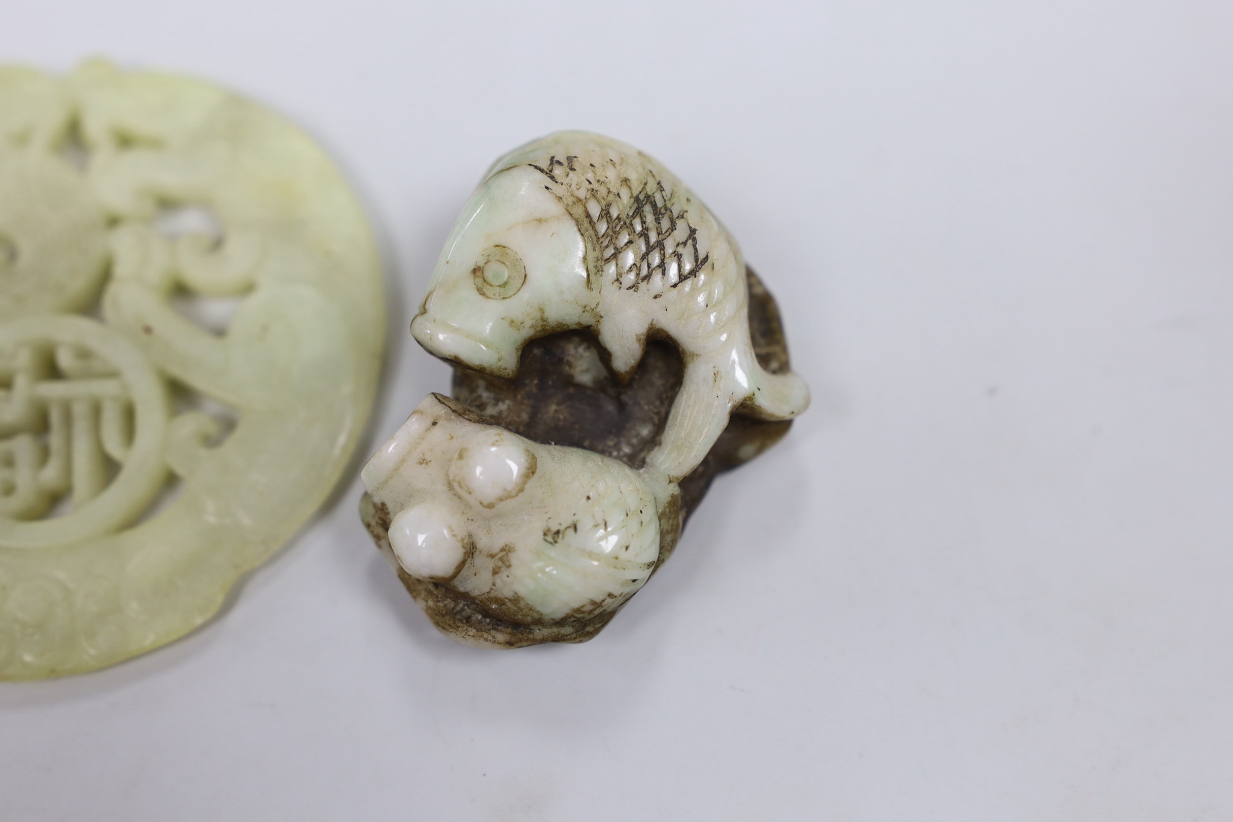 A Chinese hardstone carved roundel, a ring and a fish panel, roundabout 7cm diameter